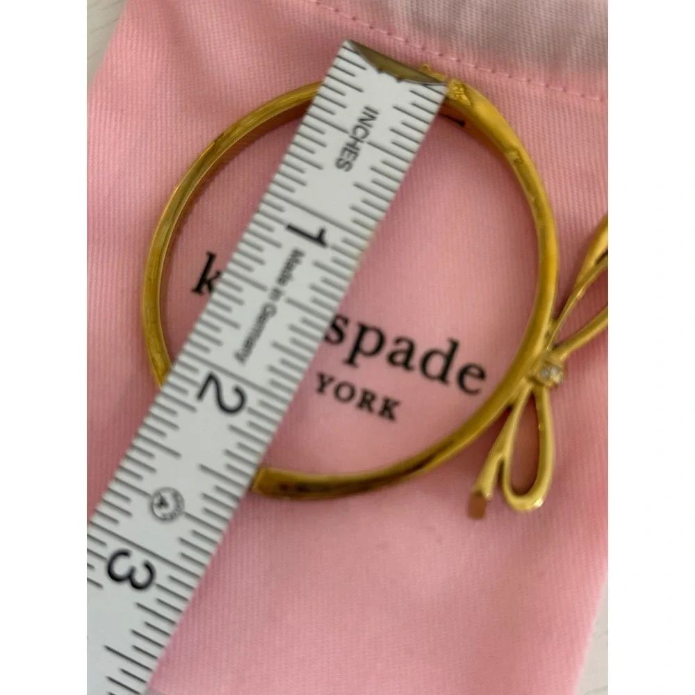 Kate Spade New York Gold Tone Pave Crystal Bow Hinged Bangle Bracelet with Bag